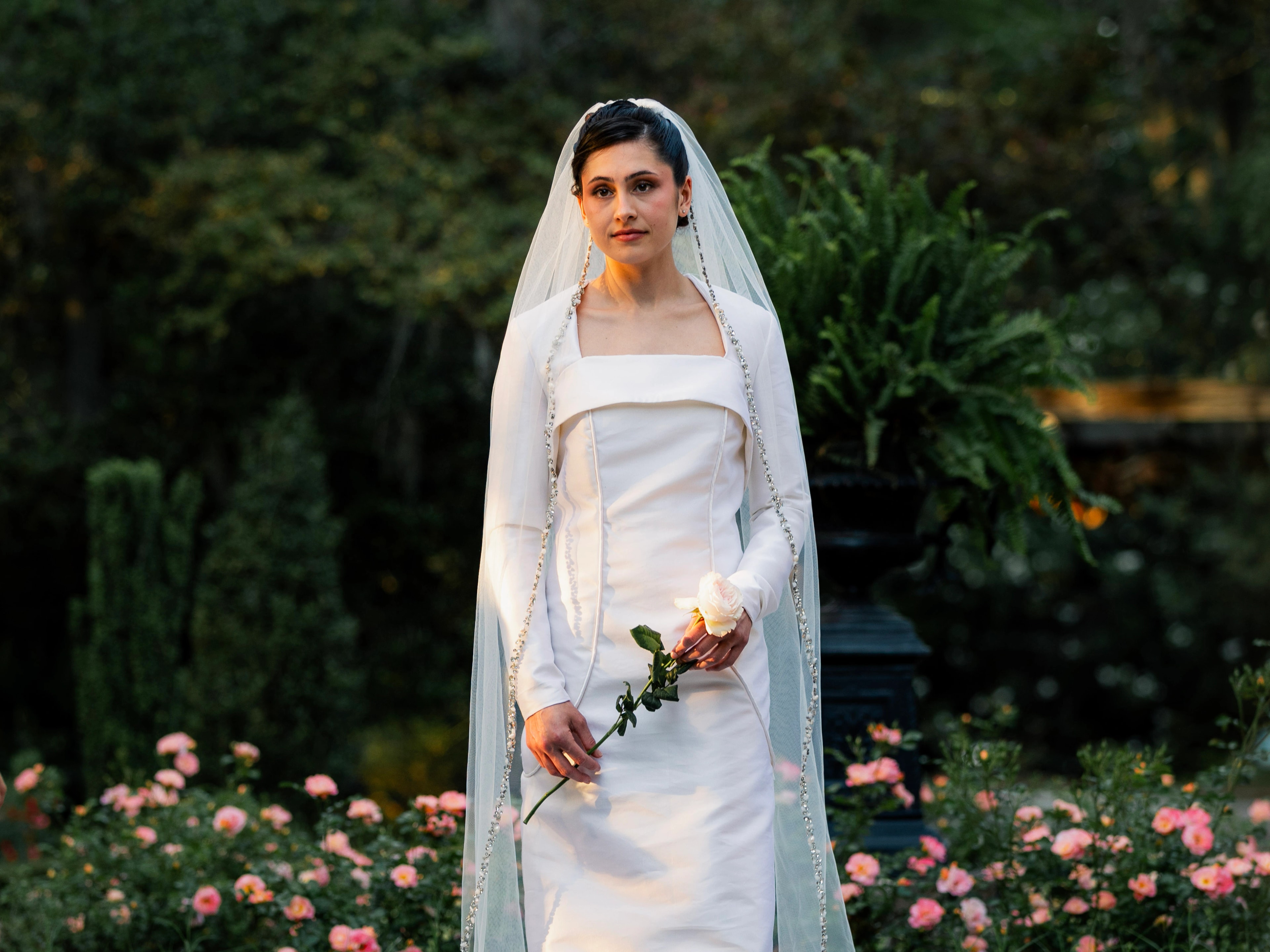 Niah long-sleeve wedding dress with a sculptural layered bodice in a garden