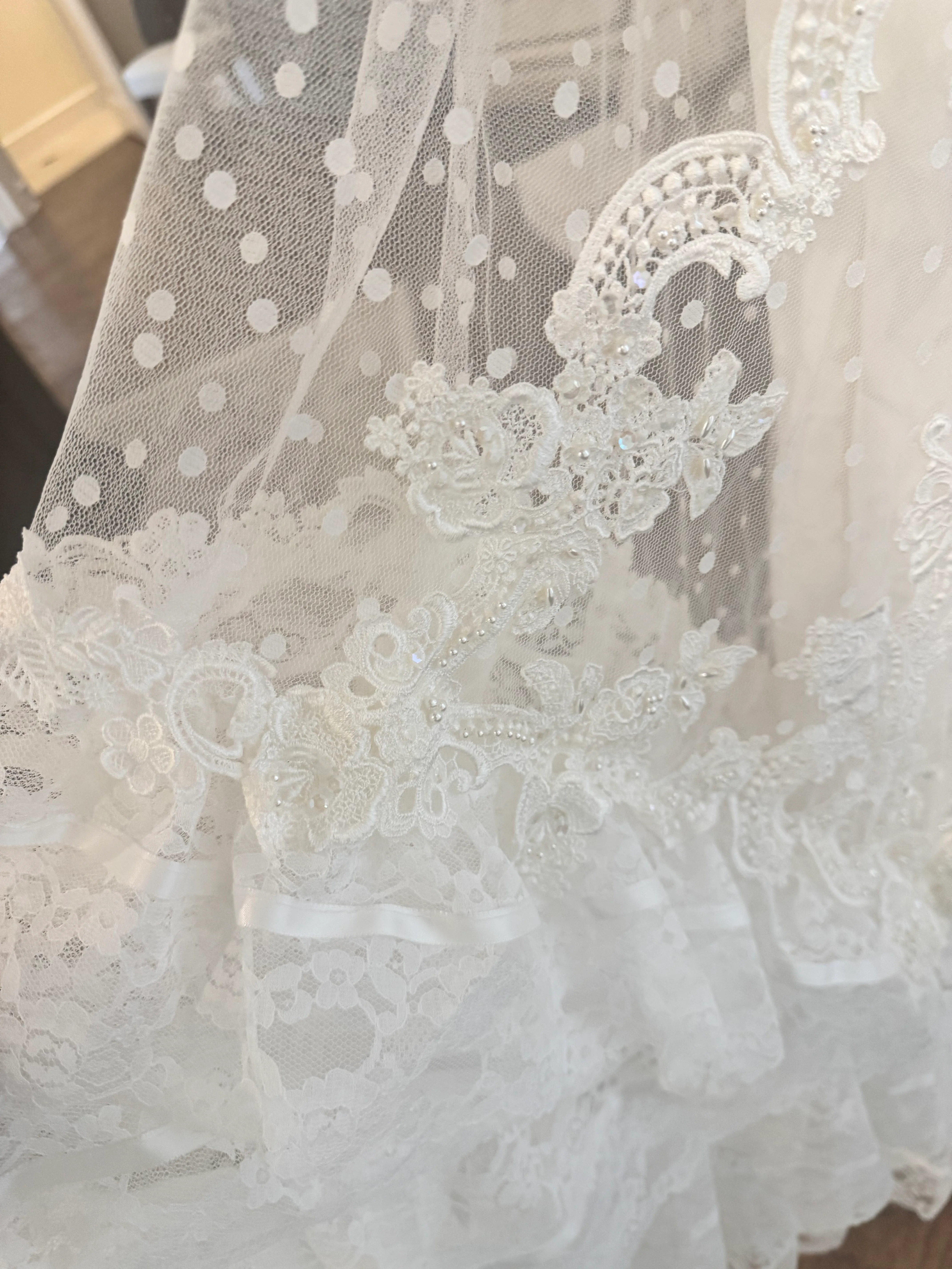 A close process detail of polka dot tulle and lace applique from the redesigned dress.