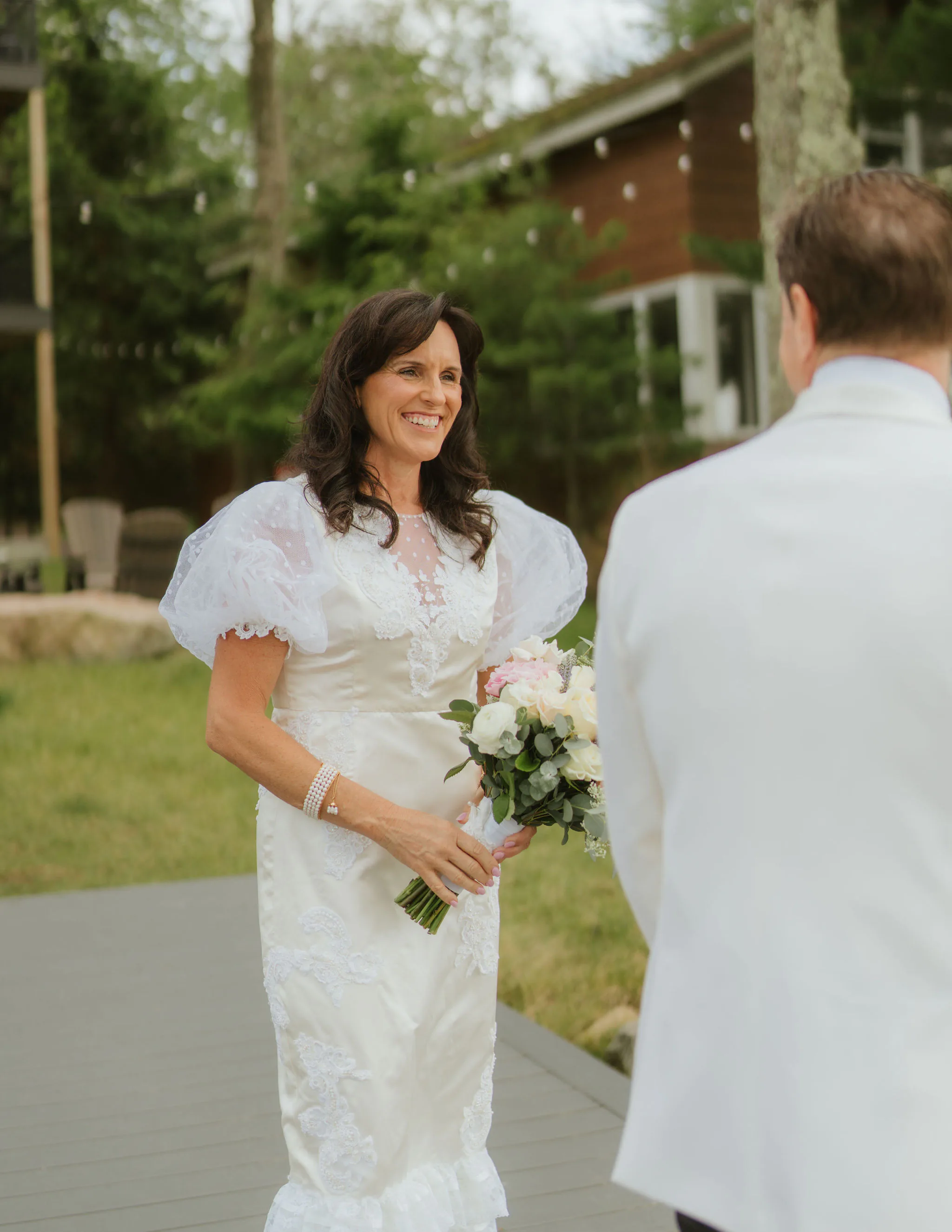 Samantha Covey's mother smiling during the vow renewal ceremony while wearing her redesigned wedding dress.