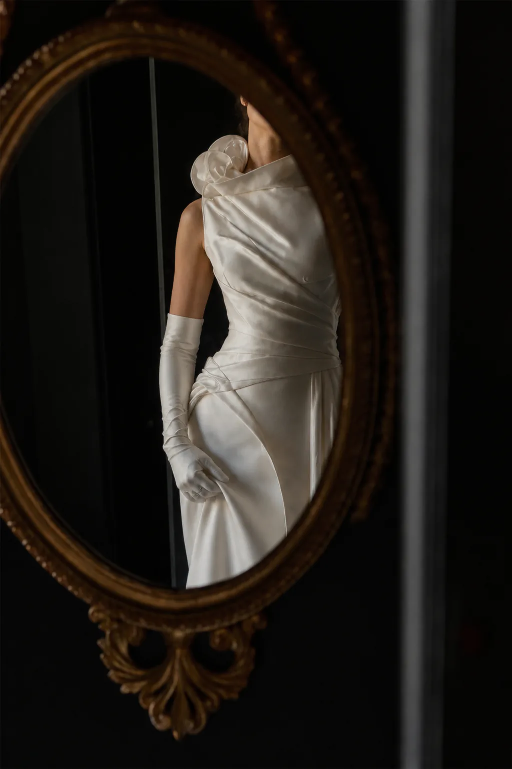 Mirror portrait showing Odette wrapped satin bodice and sculpted shoulder rosette