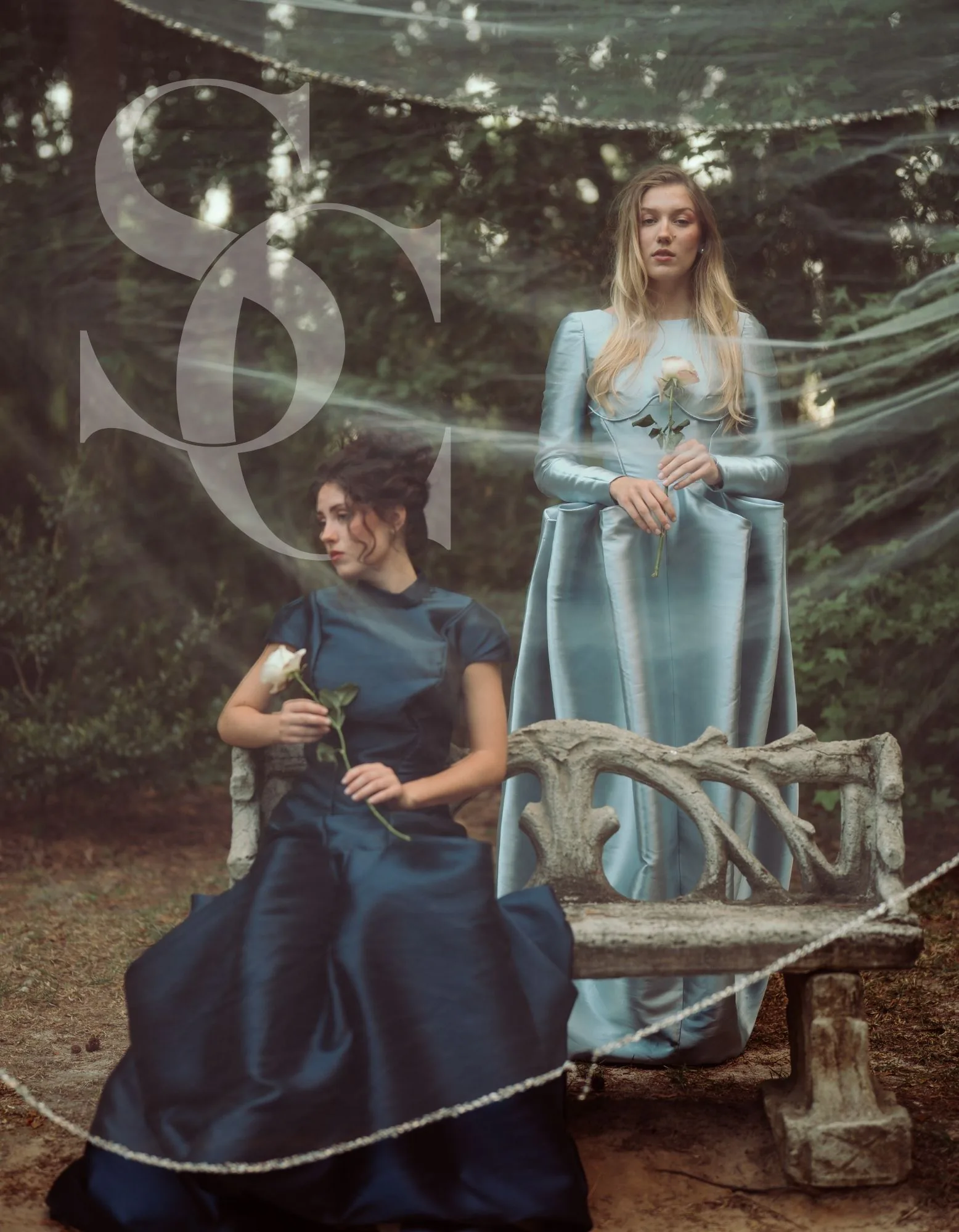 A monogrammed portrait of the navy and powder-blue gowns with large translucent initials.