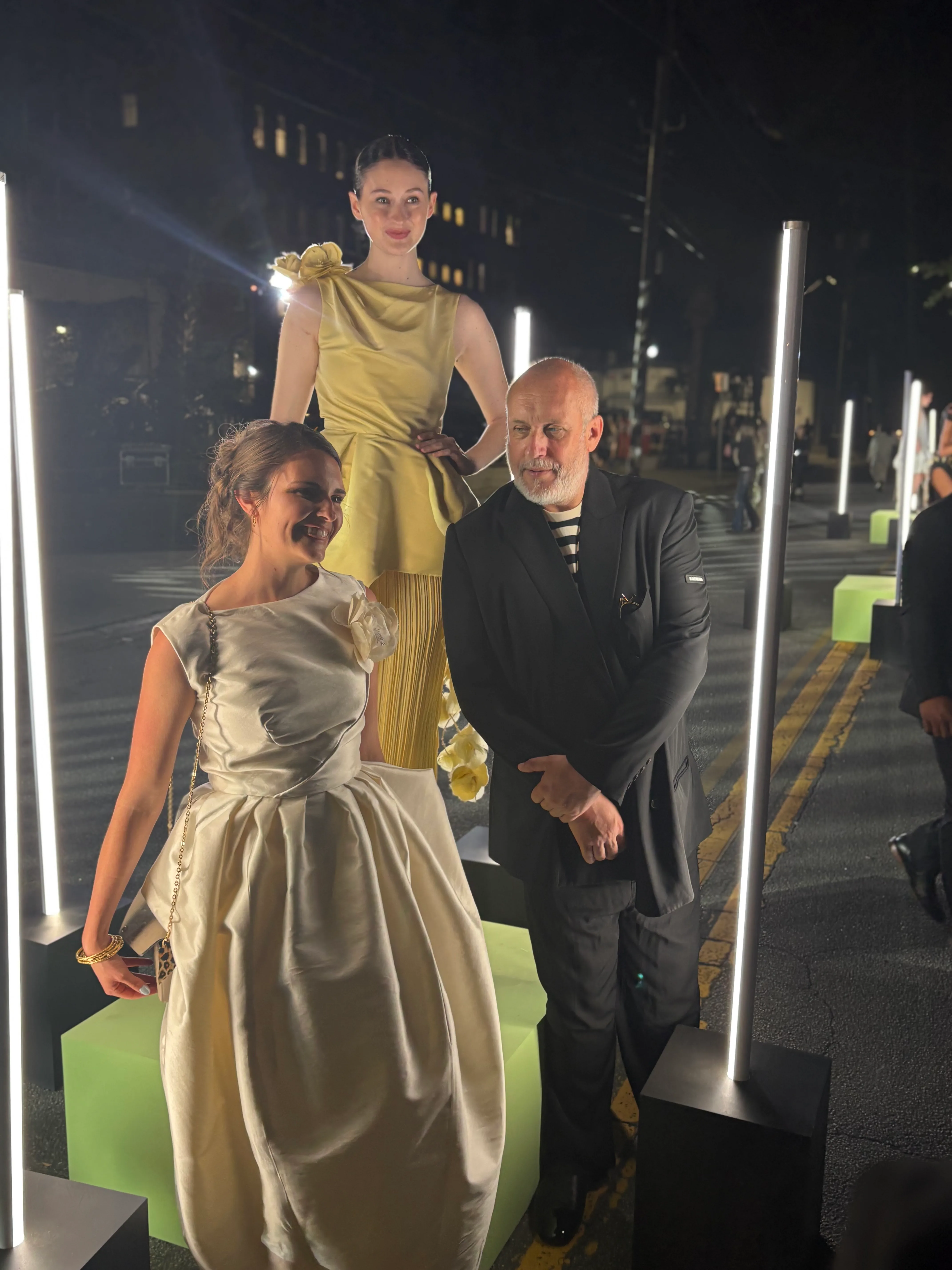 Samantha Covey standing with Peter Copping beside the displayed Lanvin-inspired dress after the SCAD Fashion Show.