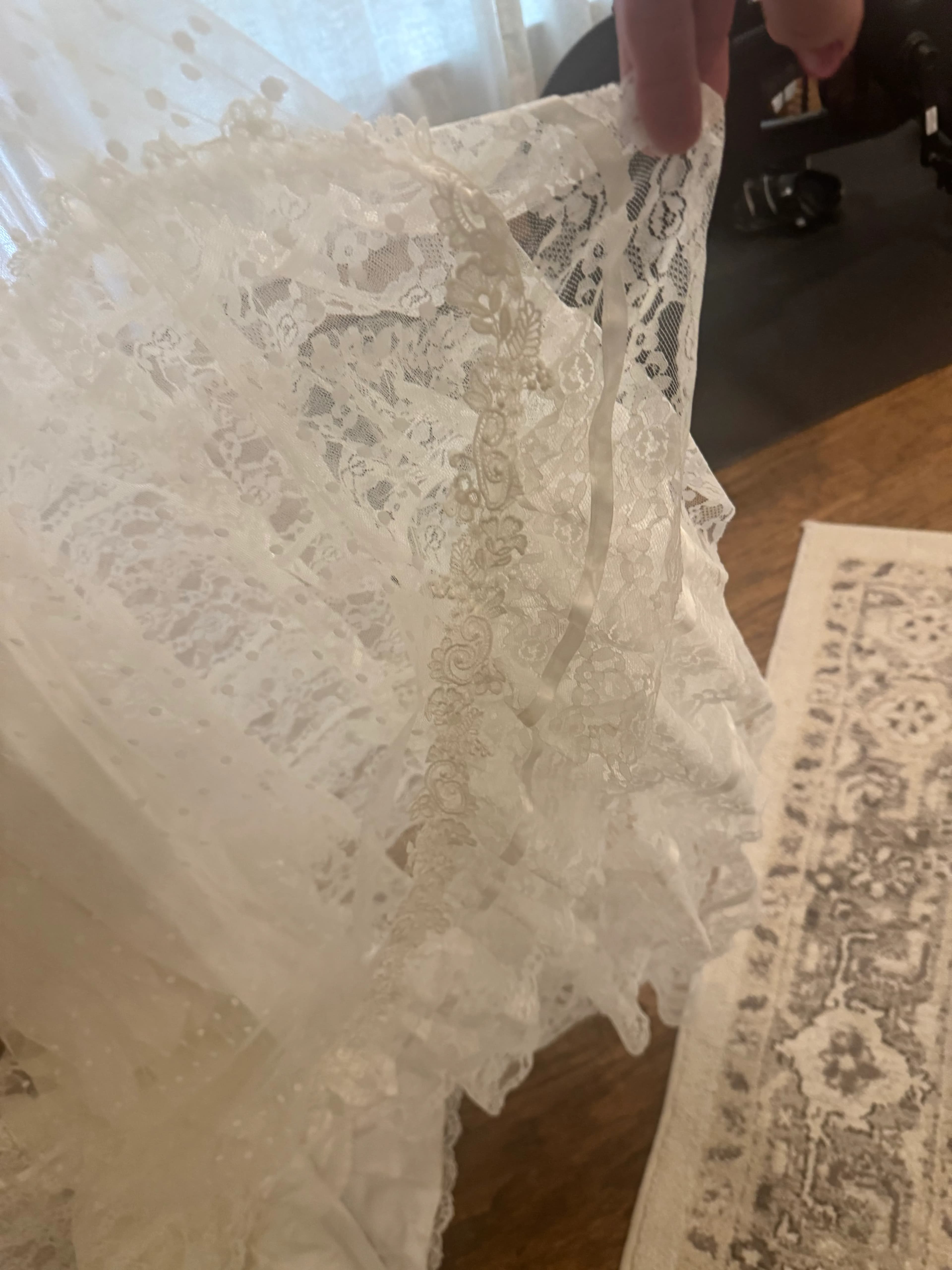 A process photo showing lace trim being separated and reworked for the dress redesign.