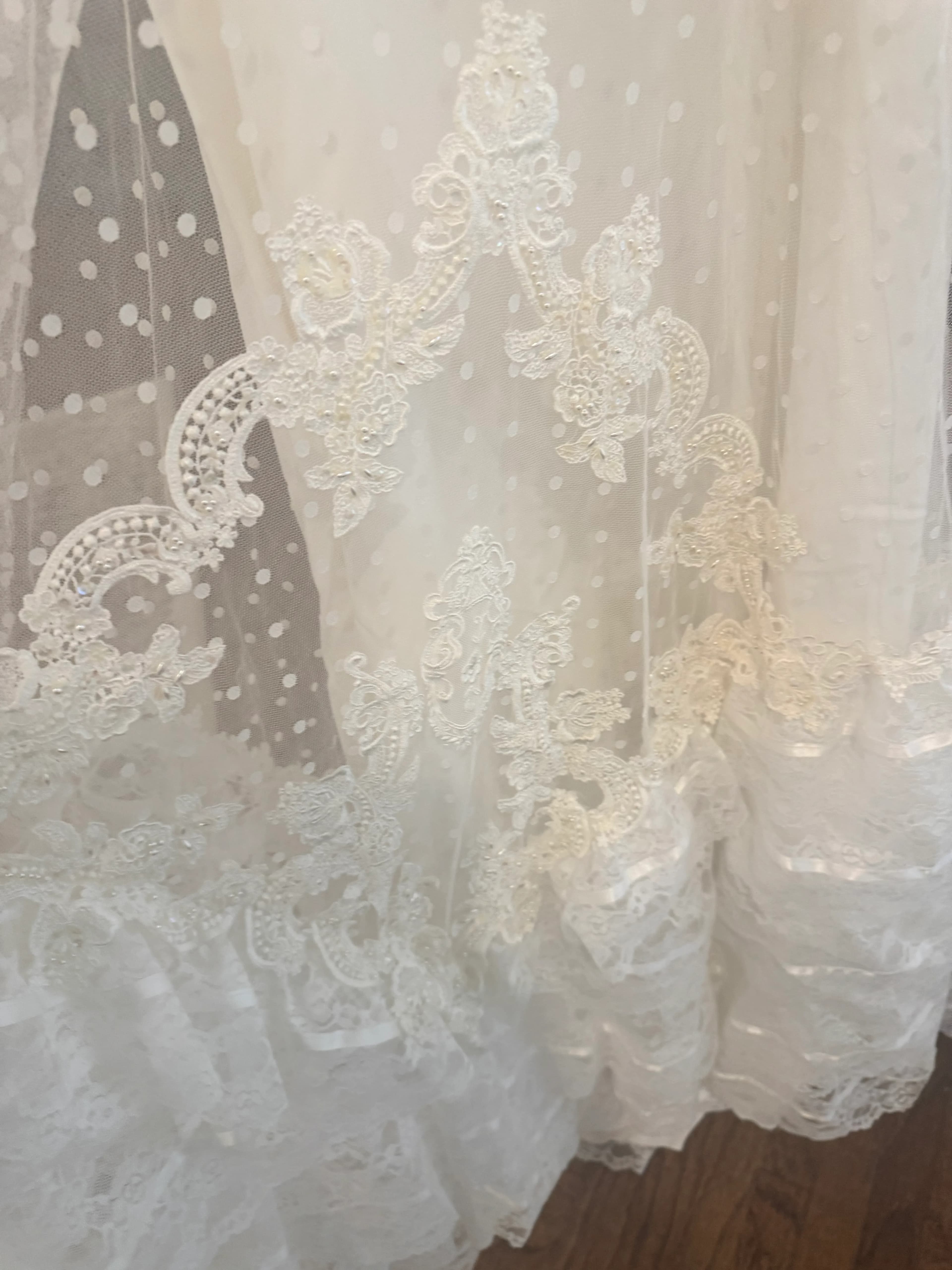 A close process detail of the original dress lace, polka dot tulle, and trim.